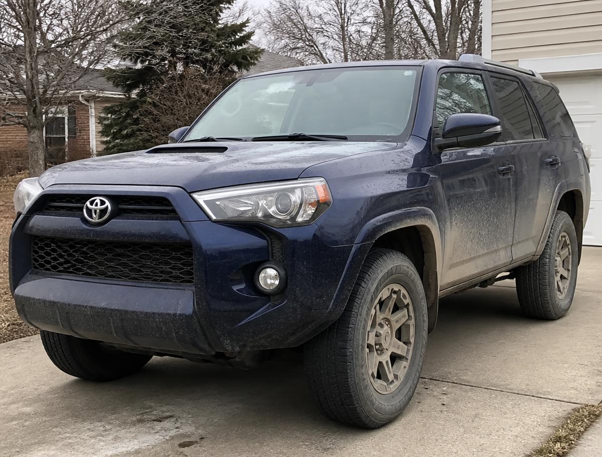 Dirty SUV in a driveway before washing